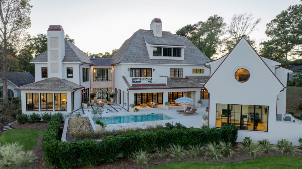 La Paloma at dusk. A generous covered terrace serves as the primary outdoor living space, offering comfort, scale, and usability throughout the seasons. Defined by its architectural ceiling and anchored by fully scaled furnishings, it invites gathering, conversation, and quiet moments alike, all within a setting that feels as considered as the interiors.