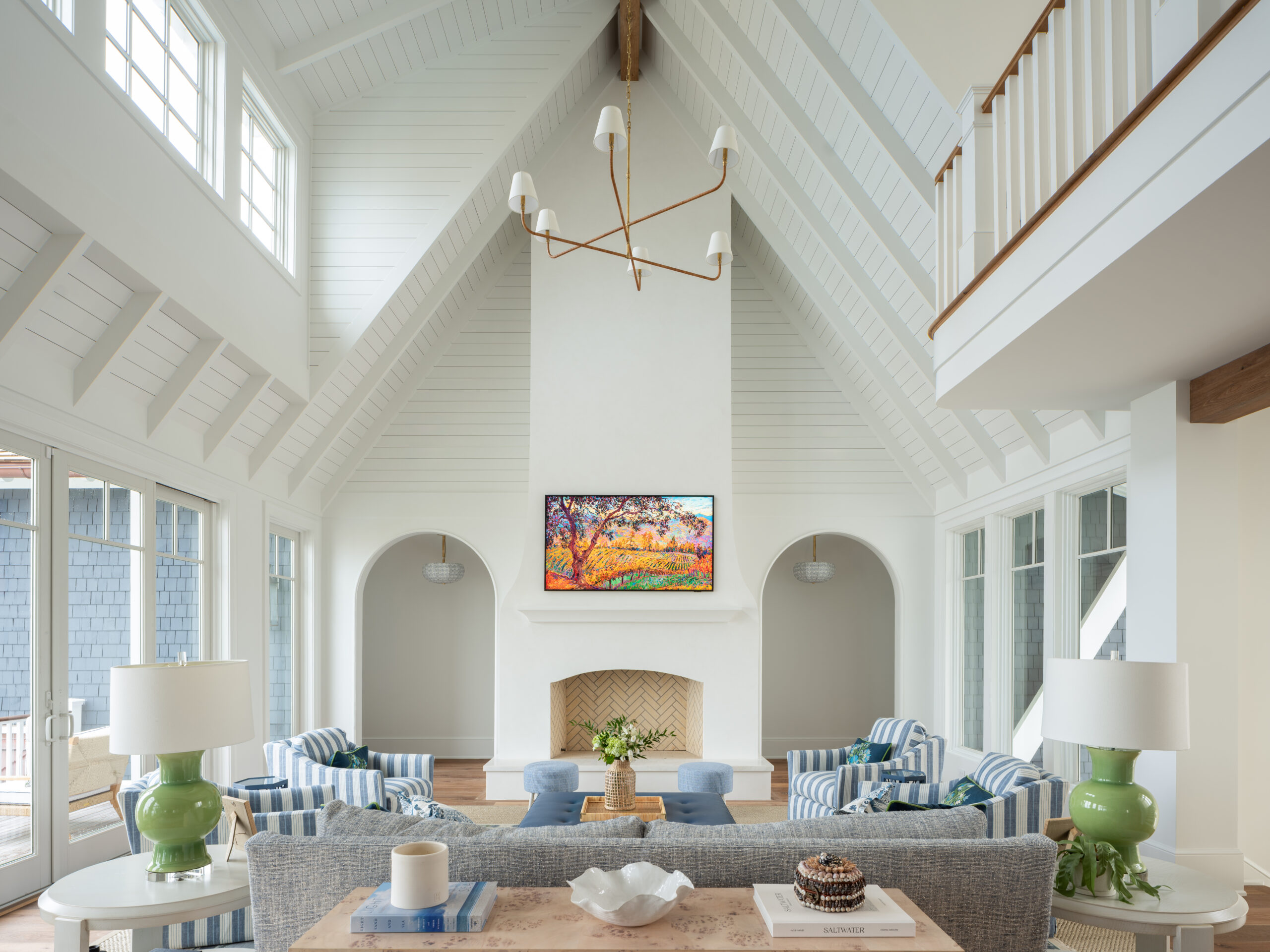 Open coastal living room at Project Inlet View with vaulted ceilings, exposed beams, soft neutral finishes, abundant natural light, and expansive views toward the Intracoastal Waterway designed for both gathering and retreat.
