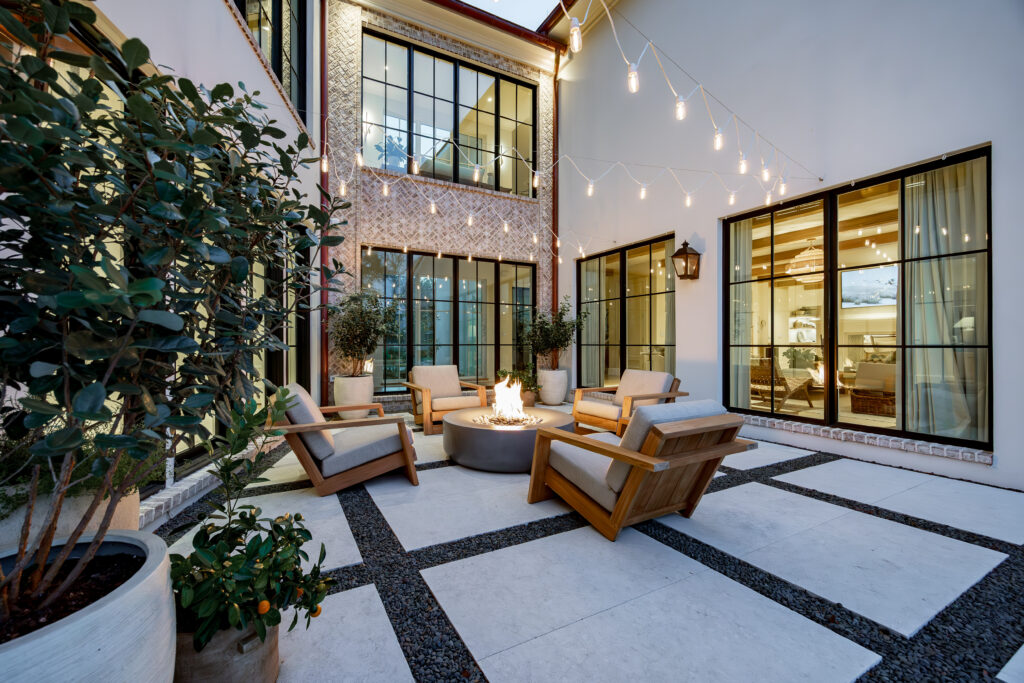 The outdoor spaces at La Paloma include, pictured here, a cozy firepit under twinkling Edison bulb lights, just steps away from a plunge pool.